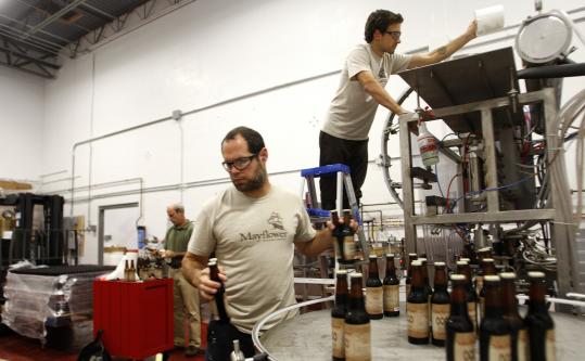 Director of operations/head brewer Matthew Steinberg (foreground), brewer Ryan Gwodz (on ladder), and owner Drew Brosseau.
